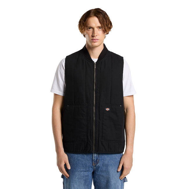 The Dickies Quilted canvas vest is a relaxed fit zip-up vest. Made out of 12OZ cotton canvas with quilted taffeta lining; this durable and stylish workwear vest with comfort wash features low pockets with metal trims and rivets; bomber collar; armhole binding; faux down padding; full metal zip; and woven Dickies label. A warm and rugged vest ready for work or adventure.