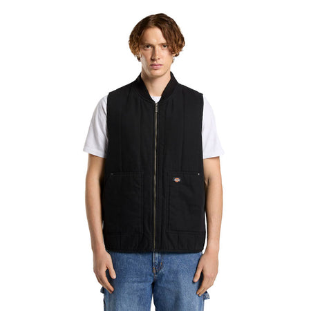 The Dickies Quilted canvas vest is a relaxed fit zip-up vest. Made out of 12OZ cotton canvas with quilted taffeta lining; this durable and stylish workwear vest with comfort wash features low pockets with metal trims and rivets; bomber collar; armhole binding; faux down padding; full metal zip; and woven Dickies label. A warm and rugged vest ready for work or adventure.