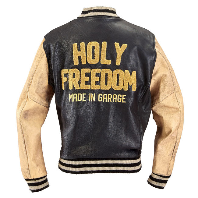 Embrace the spirit of classic college style fused with rugged biker functionality in the Holy Freedom Varsity black jacket. Crafted entirely from 100% buffalo leather; this jacket offers both durability and a timeless aesthetic. The inner lining; made of 100% red silk; adds a touch of luxury; while the cotton ribbed collar and cuffs ensure a snug fit. Designed with practicality in mind; it features two outer zippered pockets and two internal pockets; providing ample storage for your essentials. The snap clo