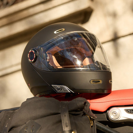The By City 90 Degrees helmet is the ultimate modular helmet for taking it all on the road in the most stylish way possible. Crafted with a lightweight fiberglass shell and multi-density padding; it ensures optimal protection and comfort for riders. The injected visor provides clear visibility; while ventilation inlets maintain airflow during rides. Its removable and washable interior ensures hygiene and longevity. Equipped with a micrometric closure for secure fastening; the helmet is also Bluetooth-ready;