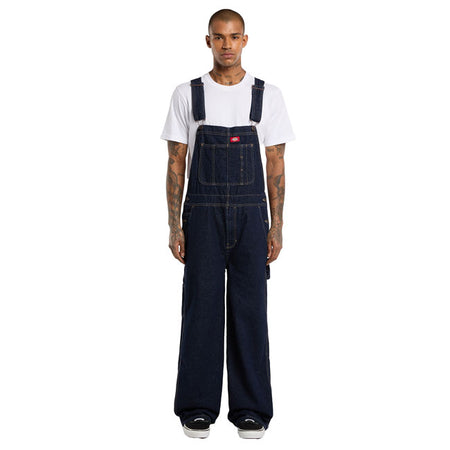 The Dickies Loose Denim Bib is a loose fit; straight leg denim bib. Made out of 14oz slub cotton denim; this bib features slanted front pockets; coin pocket;multi-tool chest pocket; zip fly; side button closure; patched back pockets; hammer loop; ruler and tool pocket; and woven Dickies labels on front above chest pocket and on back patch pocket. A work ready bib with movement and comfort built in. Available in several colors for men and female. Loose fit 100% cotton