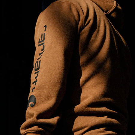 Cut the morning chill with this Carhartt Sleeve logo hoodie. A traditional cotton blend makes for versatile layering. Carhartt durability and familiar hoodie comfort mean you can strap on your tool belt or relax with equal ease. Available in a range of iconic and seasonal colors.  Loose fit Attached three-piece hood with adjustable draw cord Two lower front hand warmer pockets Stretchable; elastane reinforced rib knit cuffs and waistband Carhartt "Signature Logo" plastisol graphic print on left sleeve