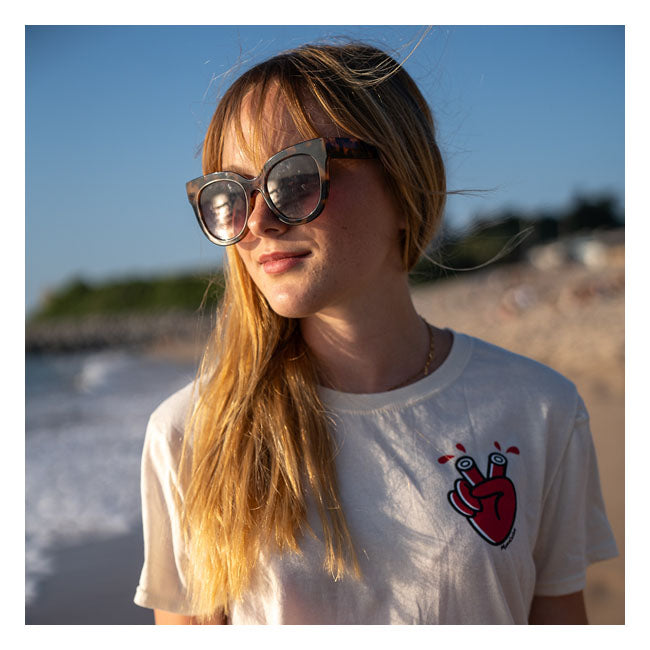 Ride Bold; Wear Loud with the Mamatee t-shirt from Holy Freedom; a fusion of edgy design and sustainable craftsmanship. Crafted from a soft and durable blend of 60% recycled cotton and 40% polyester; this t-shirt offers comfort that doesn''t compromise on eco-consciousness. Designed for a slim fit; the Mamatee features a classic crew-neck ensuring a silhouette that moves with you. The standout 3-color heart graphic adorns both the front and back. What truly sets the Mamatee apart is the exclusive artwork by